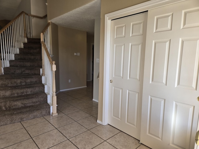 stairs featuring tile patterned flooring