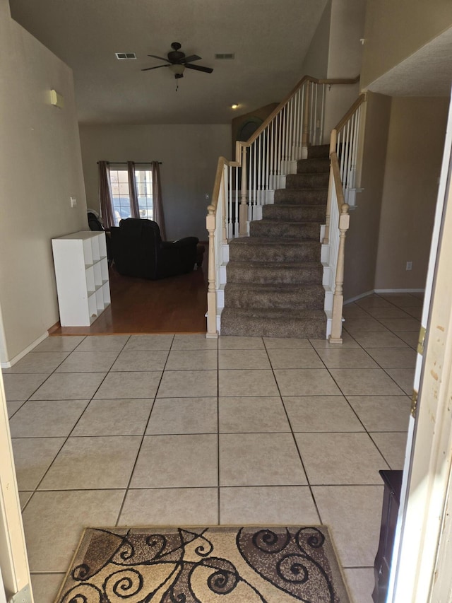 entrance foyer featuring light tile patterned floors and ceiling fan