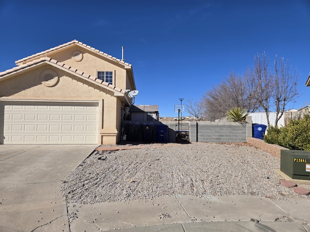 view of side of home featuring a garage