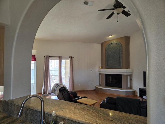 living room with ceiling fan and hardwood / wood-style flooring