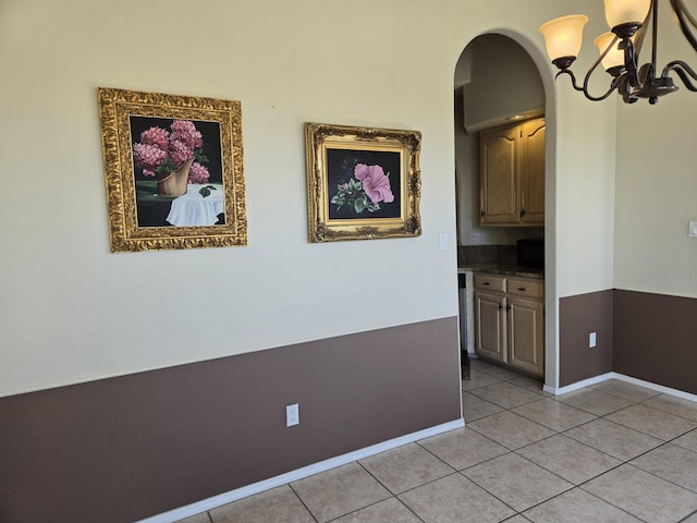 interior space with a chandelier and light tile patterned flooring