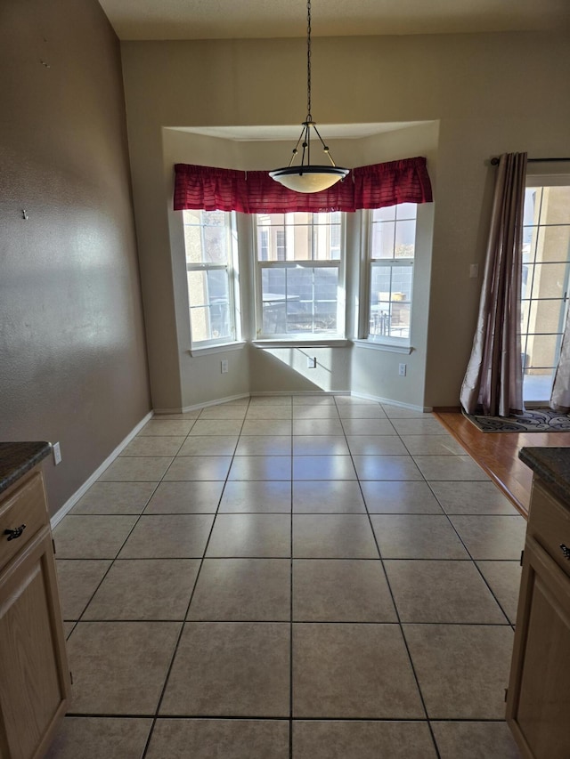 unfurnished dining area with light tile patterned floors