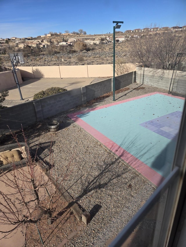 view of pool featuring basketball hoop