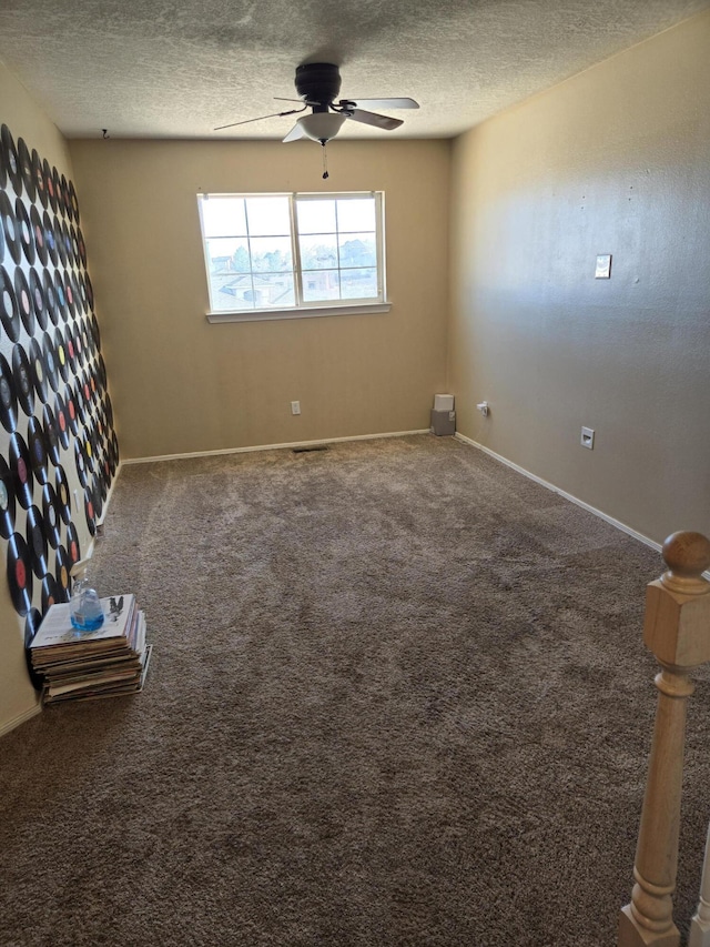 carpeted empty room featuring a textured ceiling and ceiling fan