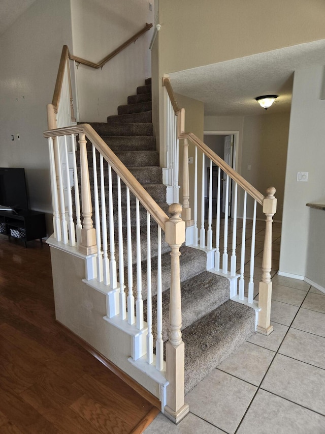 stairs featuring tile patterned flooring