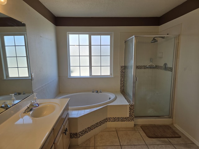 bathroom featuring plenty of natural light, tile patterned floors, vanity, and plus walk in shower