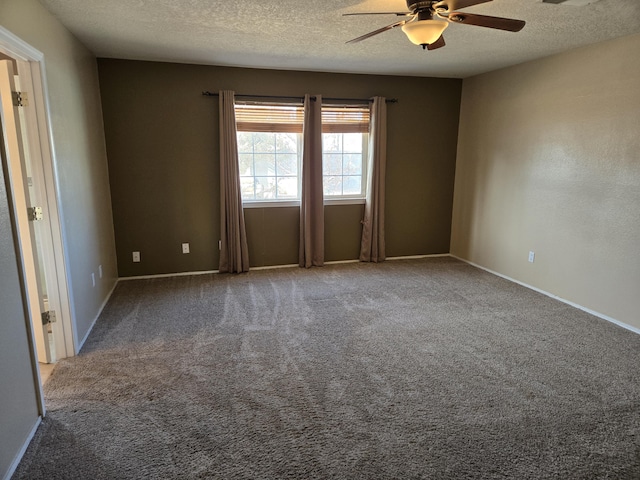 carpeted empty room with ceiling fan and a textured ceiling