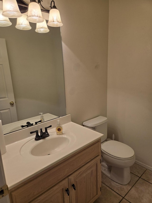 bathroom with vanity, toilet, and tile patterned flooring