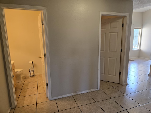 hall featuring light tile patterned floors