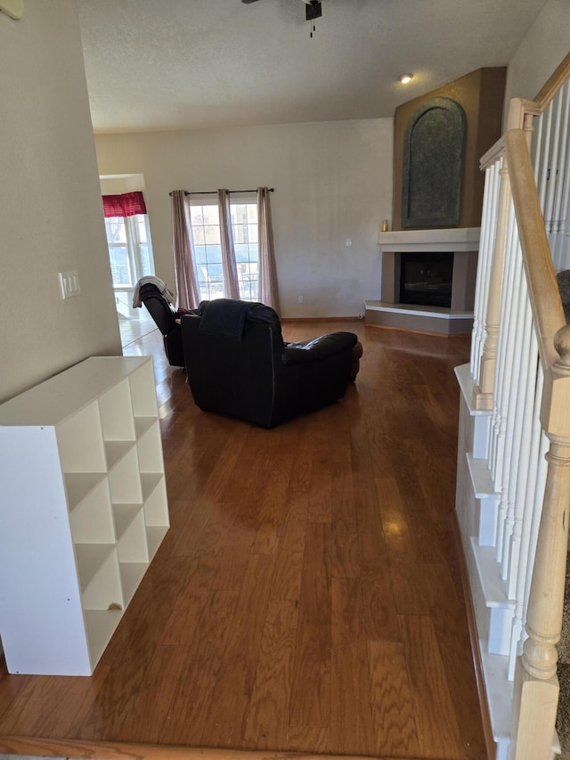 living room with ceiling fan and wood-type flooring