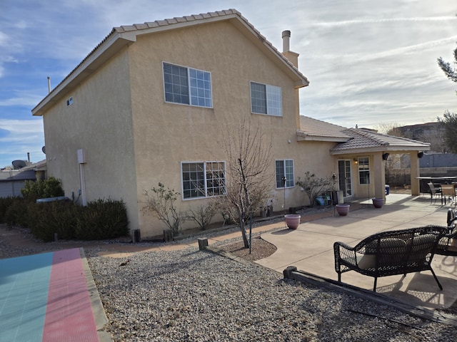 back of property featuring a patio