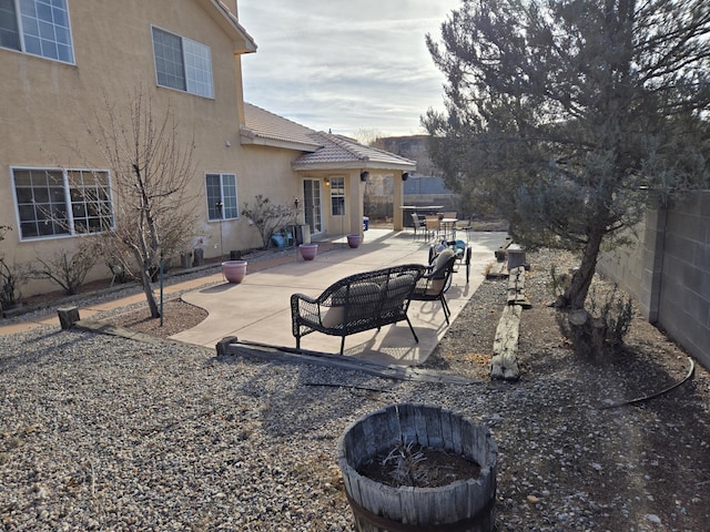 view of yard featuring a fire pit and a patio