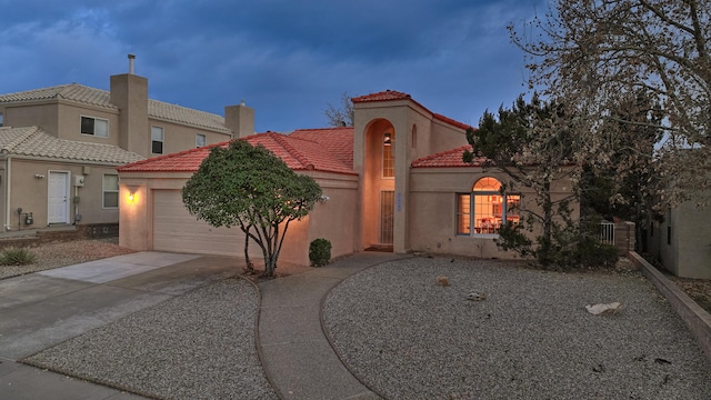 mediterranean / spanish-style house featuring a garage