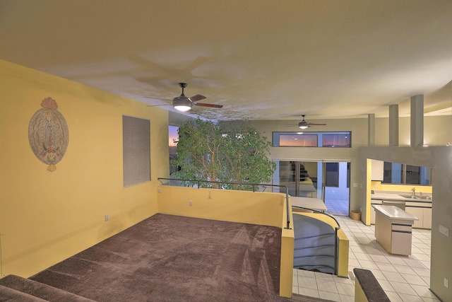 living room featuring sink and light tile patterned floors