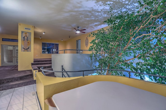 dining area featuring ceiling fan and tile patterned floors