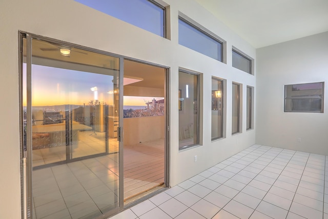 balcony at dusk featuring a patio area