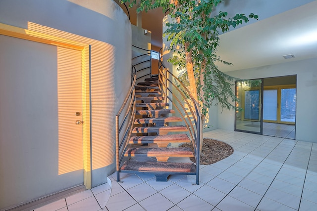 stairs featuring tile patterned flooring