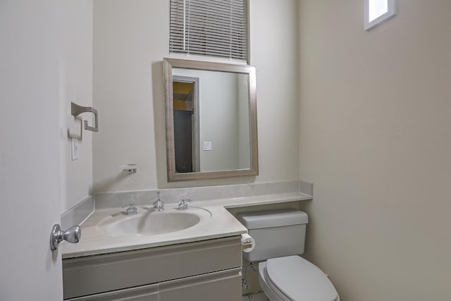 bathroom featuring toilet and vanity