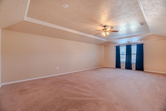 unfurnished room with a tray ceiling, carpet, a textured ceiling, and ceiling fan