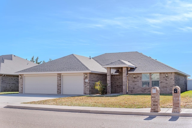 view of front of property with a front yard and a garage