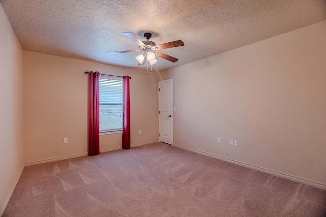 carpeted spare room featuring ceiling fan and a textured ceiling