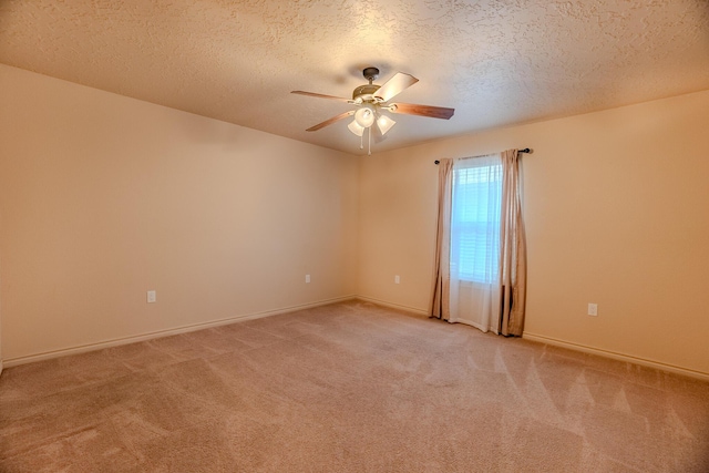 unfurnished room with a textured ceiling, carpet flooring, and ceiling fan