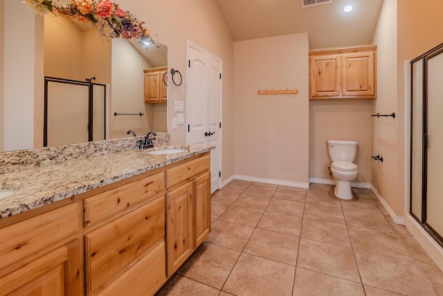 bathroom featuring toilet, a shower with shower door, vaulted ceiling, tile patterned floors, and vanity