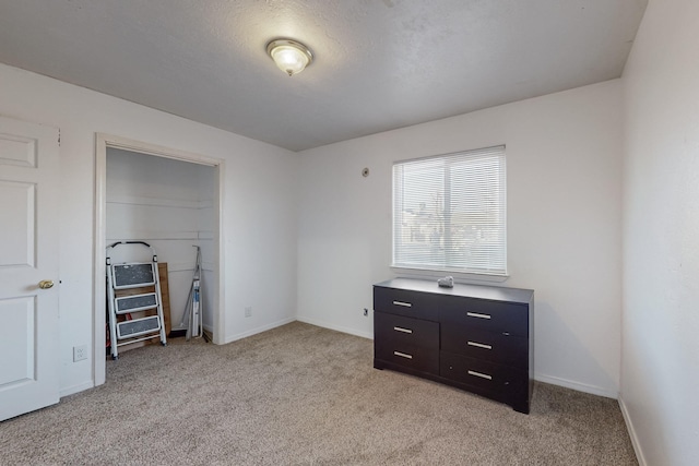 bedroom featuring light colored carpet and a closet