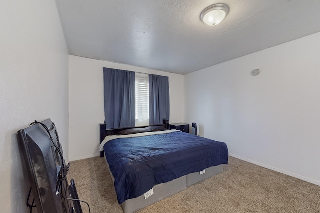 carpeted bedroom with a textured ceiling