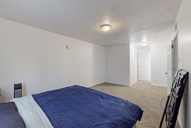 bedroom with a textured ceiling and carpet