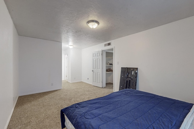 carpeted bedroom with a textured ceiling