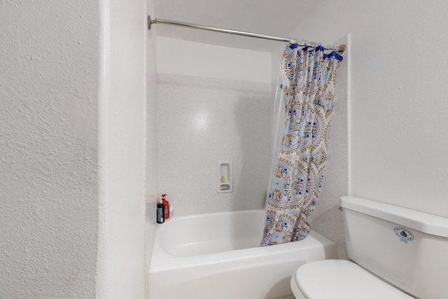 bathroom with shower / tub combo and toilet