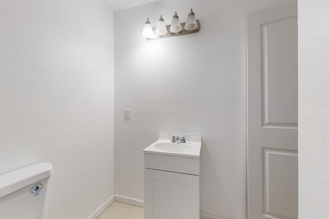 bathroom with vanity, toilet, and tile patterned flooring