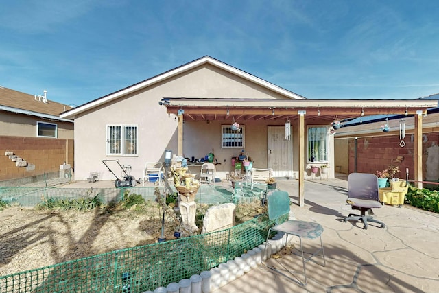 rear view of property featuring a patio area