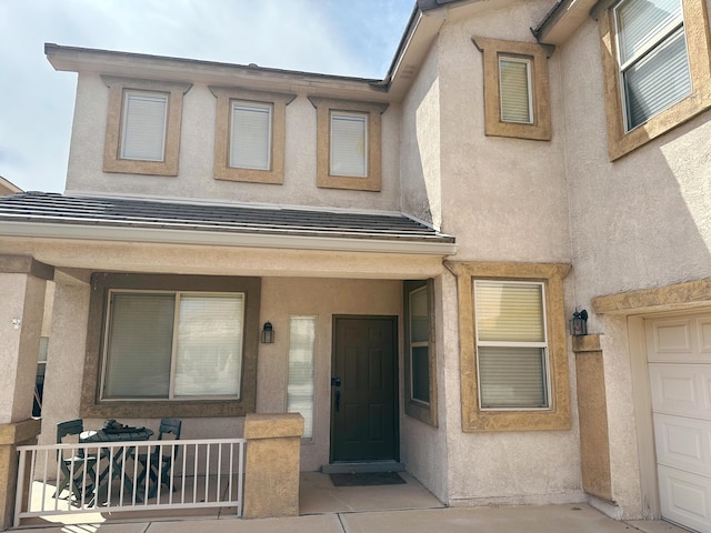 view of exterior entry with covered porch