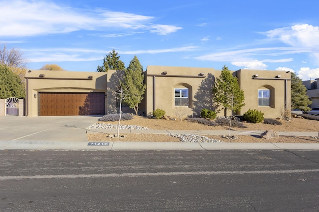 pueblo-style house with a garage