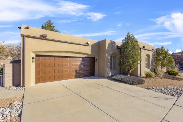 pueblo-style home with a garage