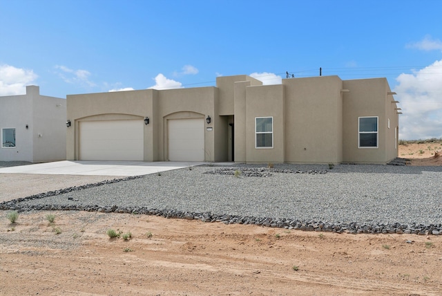 southwest-style home featuring a garage