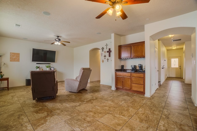 kitchen with a textured ceiling and ceiling fan