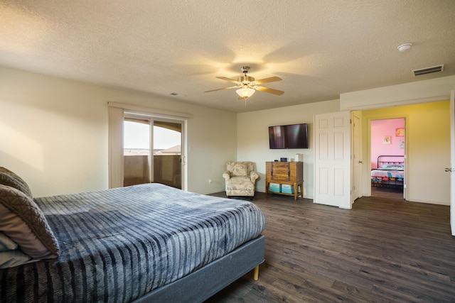 bedroom featuring a textured ceiling, dark hardwood / wood-style flooring, and ceiling fan