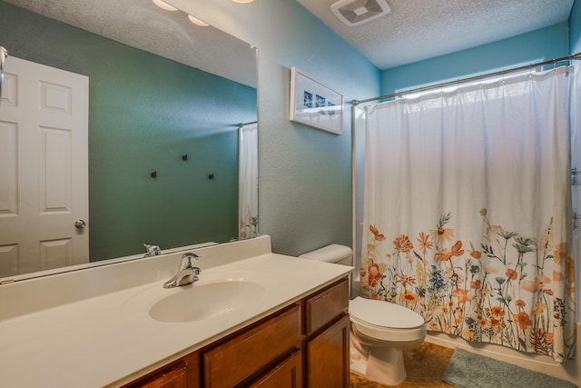 bathroom with curtained shower, vanity, a textured ceiling, and toilet