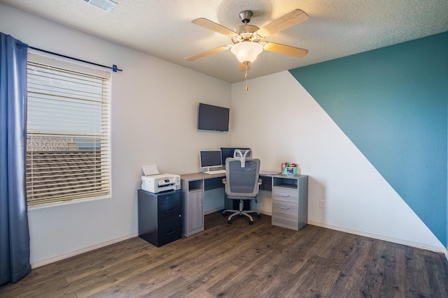 office featuring a textured ceiling, ceiling fan, and dark wood-type flooring