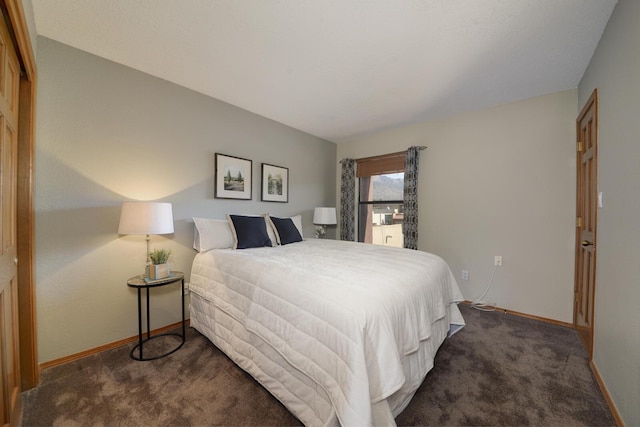 bedroom featuring dark carpet and a closet