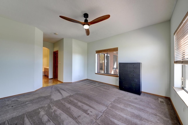 carpeted empty room with ceiling fan