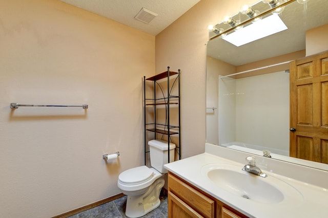 bathroom with tile patterned floors, a shower, a textured ceiling, toilet, and vanity