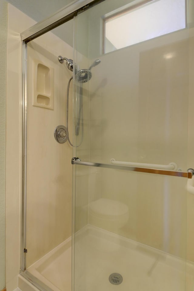 bathroom with a shower with door