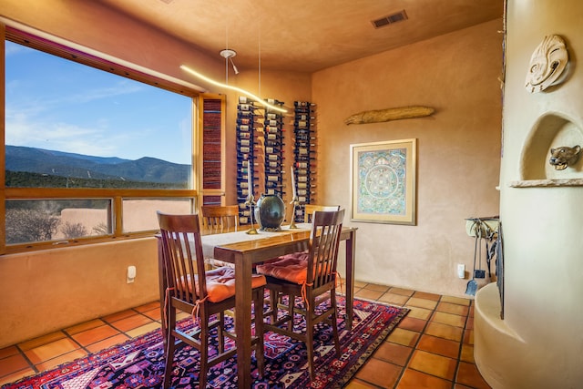 dining area with tile patterned flooring and a mountain view