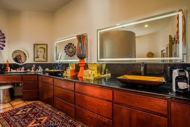 bathroom featuring tile patterned flooring, vanity, and backsplash