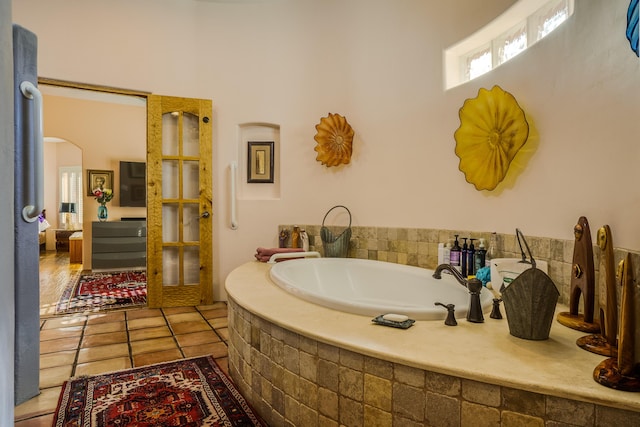 bathroom featuring tile patterned floors and tiled bath