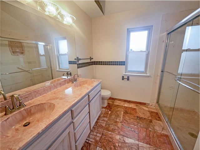 bathroom featuring toilet, an enclosed shower, and vanity